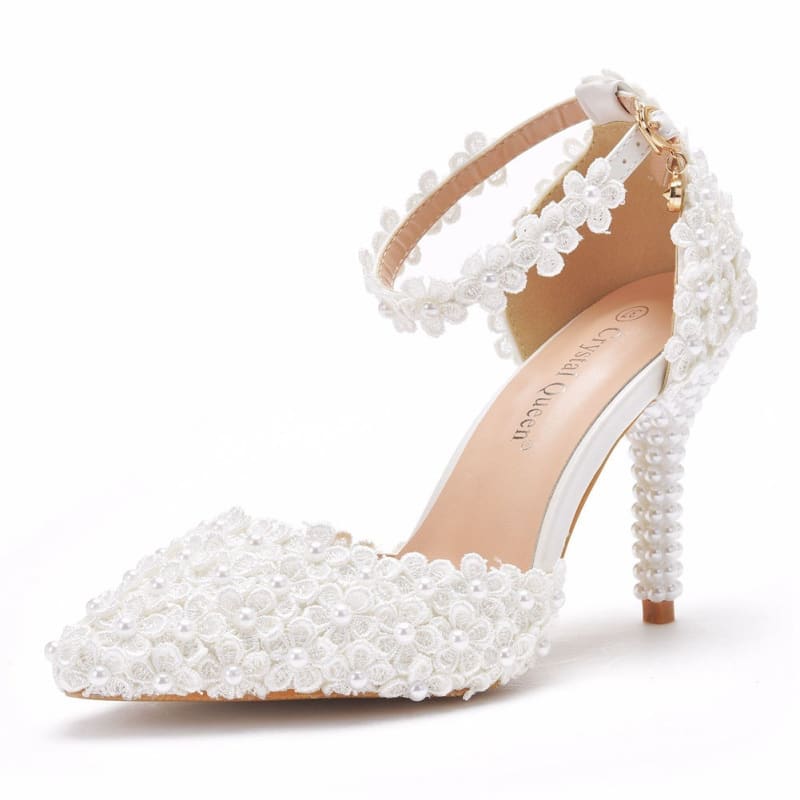 White lace pointed toe high stiletto wedding shoes adorned with pearls and ankle strap.