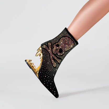 Ornate black ankle boot with gold skull design and metallic heel.