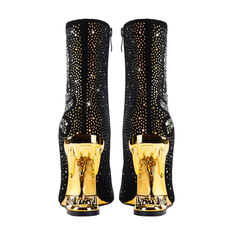 Pair of black ankle boots with gold metallic heels and sparkly embellishments.