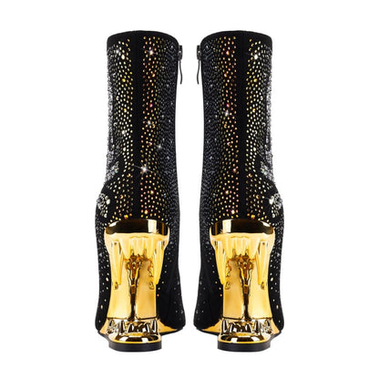 Pair of black ankle boots with gold metallic heels and sparkly embellishments.