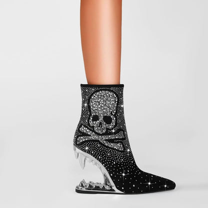 Sparkly black ankle boot with a skull design and clear wedge heel.