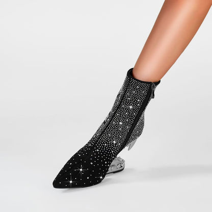 Sparkly black ankle boot with a pointed toe and clear heel.