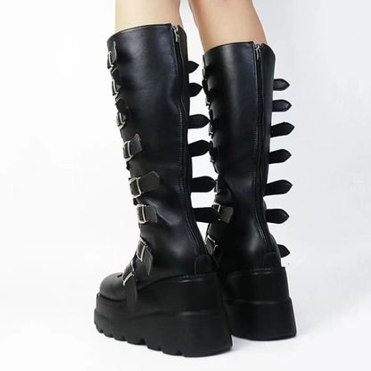 Tall black leather platform boots with multiple buckles and spikes along the sides.