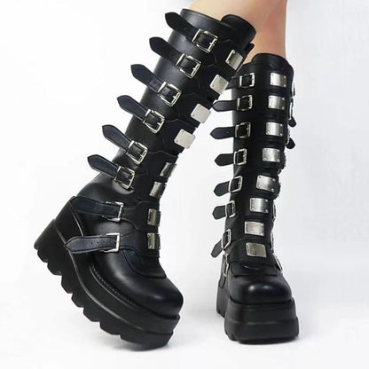 Pair of tall black platform boots with multiple buckle straps.