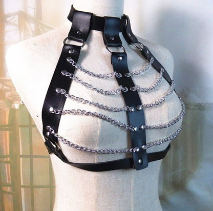 Leather harness with metal chains forming a cage-like structure across the chest.