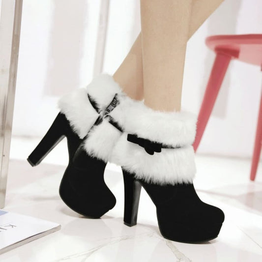 Black high-heeled ankle boot with white fur trim and a platform sole.