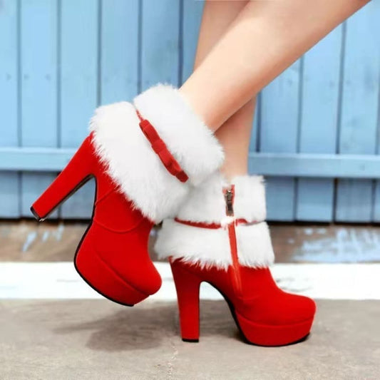 Red high-heeled boots with white fur trim, reminiscent of Santa Claus-themed footwear.