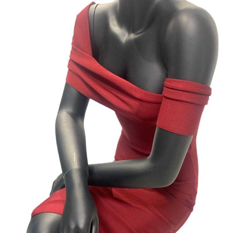 Mannequin torso wearing a red off-shoulder dress.