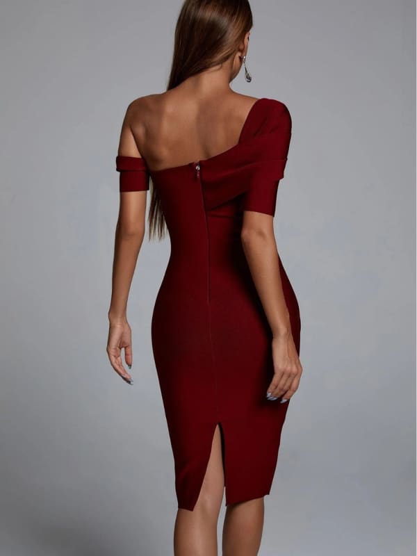 Form-fitting red dress with an asymmetrical neckline and short sleeves.