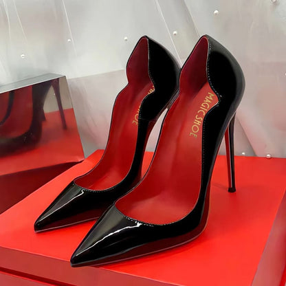 Pair of glossy black stiletto high heels with red soles.