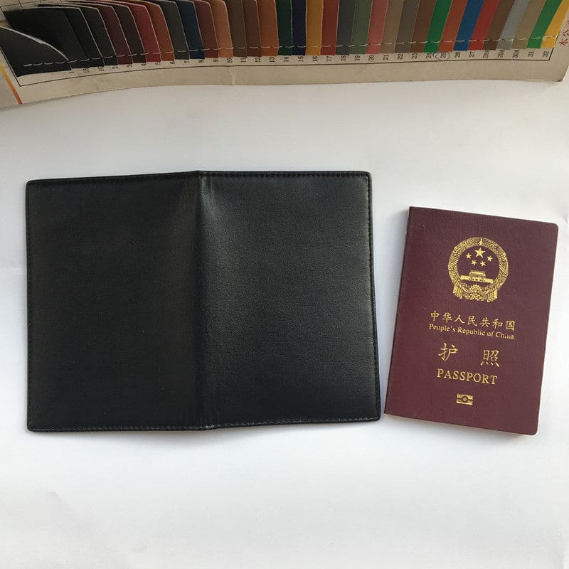 Chinese passport alongside a black leather wallet or document holder.