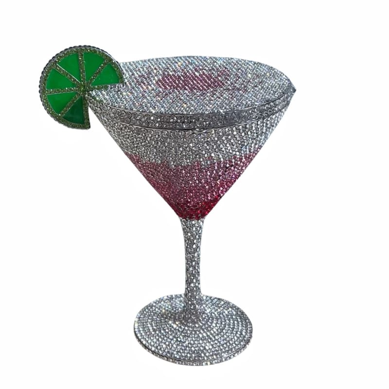 Glittery cocktail glass with a decorative lime slice garnish.