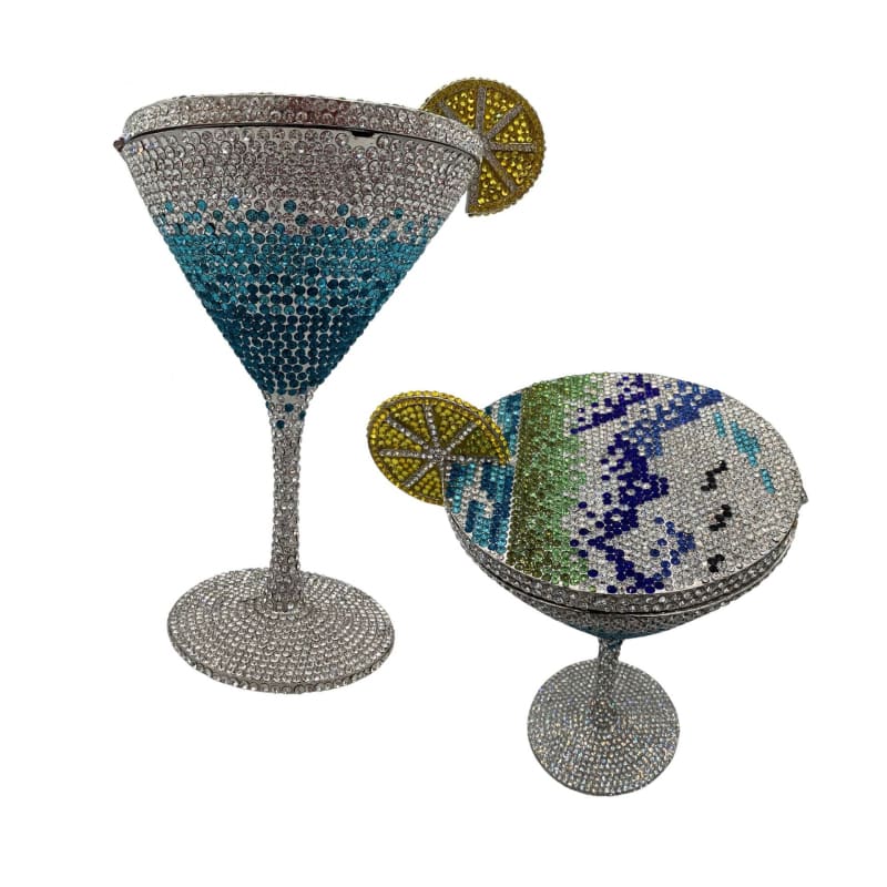 Two bejeweled cocktail glasses adorned with crystal-like decorations and lime slice garnishes.