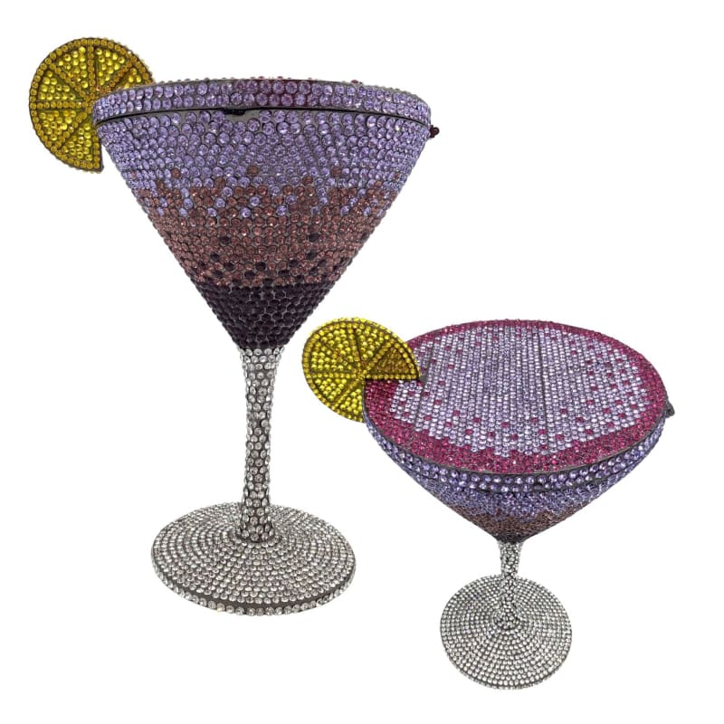 Two bejeweled cocktail glasses adorned with crystal-like stones and decorative lemon slices.