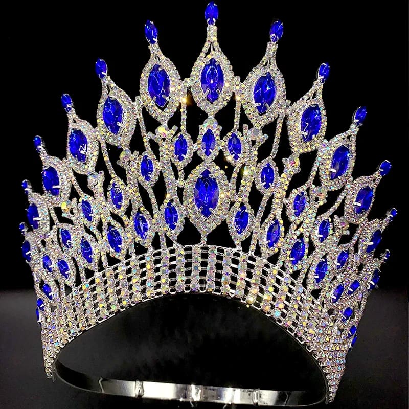 Ornate silver rhinestone wedding crown tiara with blue gemstones and crystals.