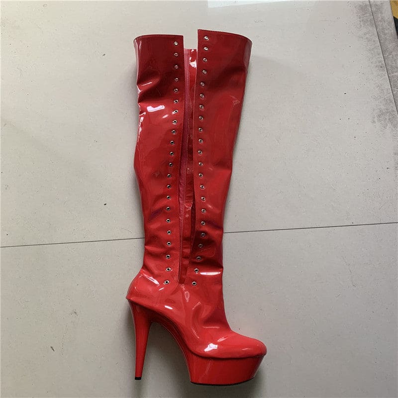 Shiny red thigh-high platform boot with studs along the front seam.