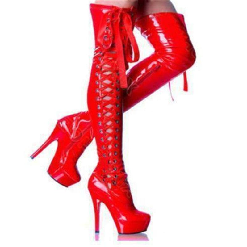 Bright red, shiny, thigh-high platform boots with laces up the front.