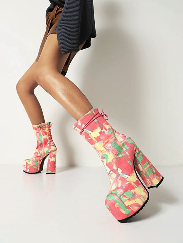 Colorful platform ankle boots with a floral pattern and chunky heels.