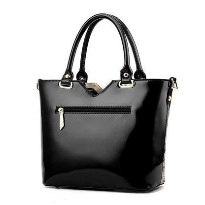 Black leather handbag with handles and a front zipper pocket.