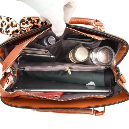 Open handbag containing various personal items and makeup products.