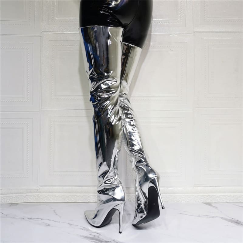 Shiny metallic silver thigh-high boots with stiletto heels.