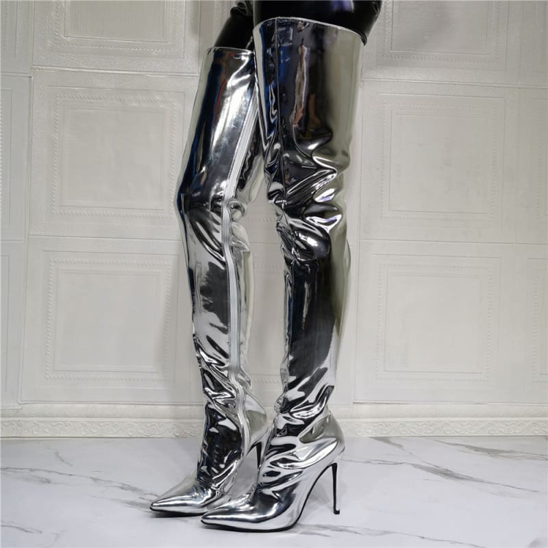 Shiny silver thigh-high stiletto boots with a pointed toe.