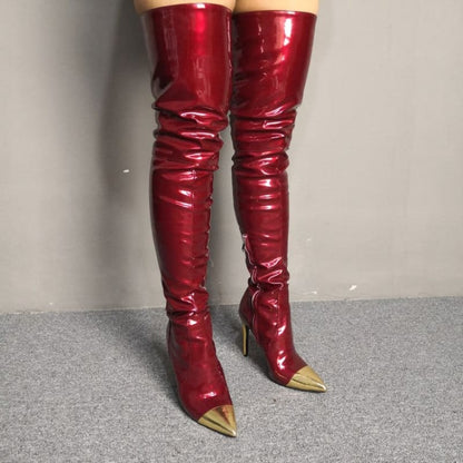 Pair of shiny red thigh-high boots with metallic gold pointed toes.