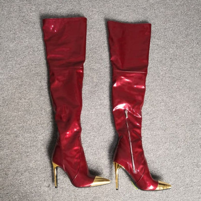 Pair of shiny red thigh-high boots with gold stiletto heels and pointed metallic toe caps.