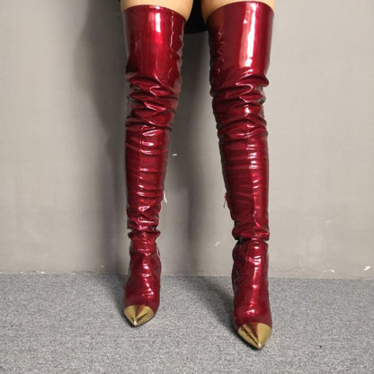 Pair of shiny red thigh-high boots with pointed gold toe caps.