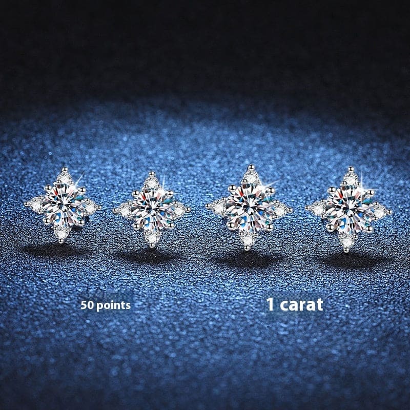 Four sparkling diamond stud earrings arranged in a row.