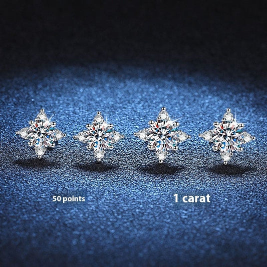 Four sparkling diamond stud earrings arranged in a row.