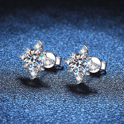 Pair of snowflake-shaped diamond stud earrings.