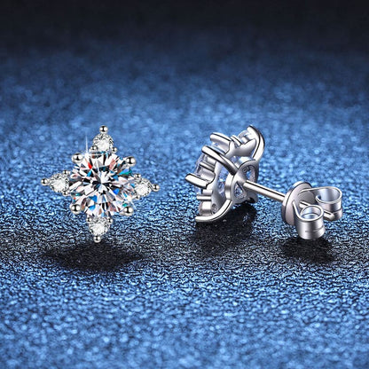 Pair of sparkling diamond stud earrings with a snowflake-like design.