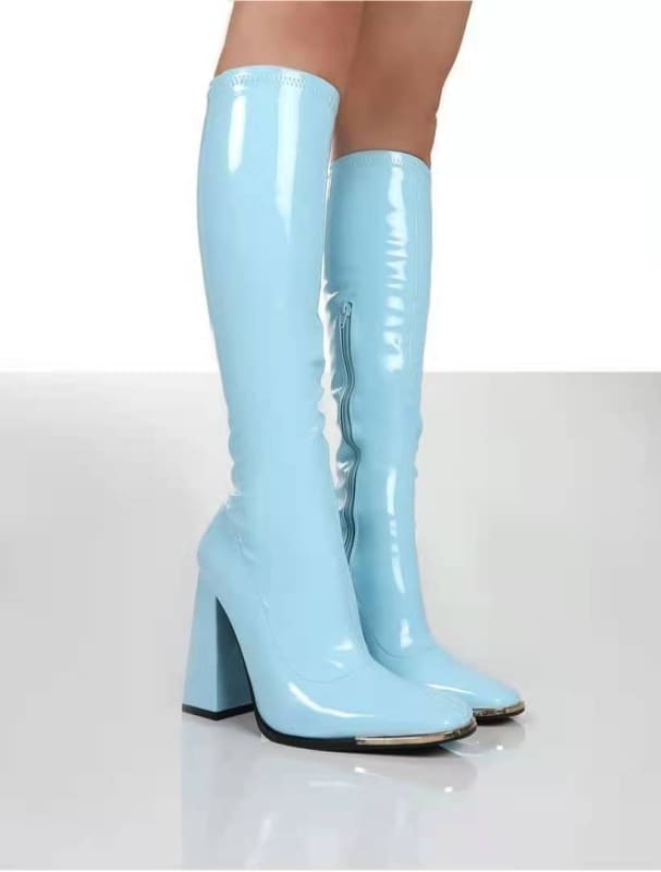 Pair of knee-high, light blue patent leather boots with chunky heels.