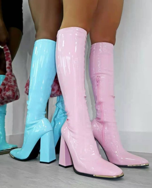 Shiny knee-high boots in pastel blue, light pink, and pale pink colors with chunky heels.