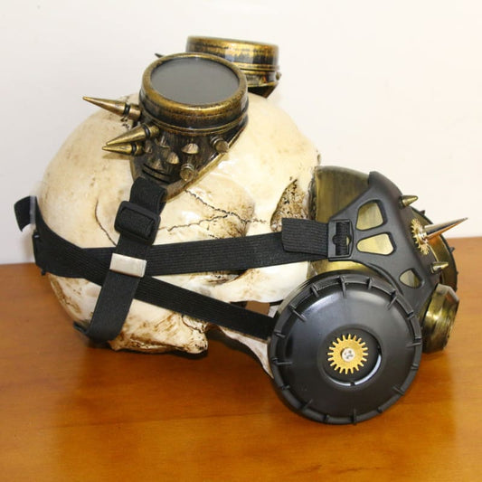 Steampunk-style gas mask with brass goggles and spikes attached to a white skull.