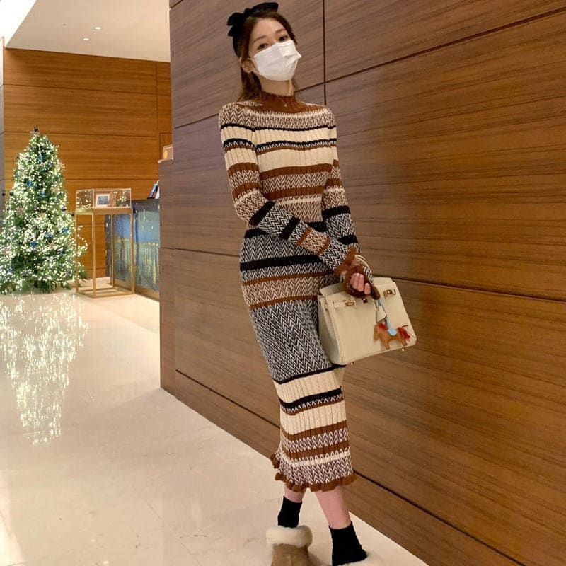 Striped knit dress with a turtleneck worn by a person in a face mask.