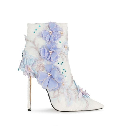 Ornate white high-heeled ankle boot adorned with pastel floral appliqués and beading.