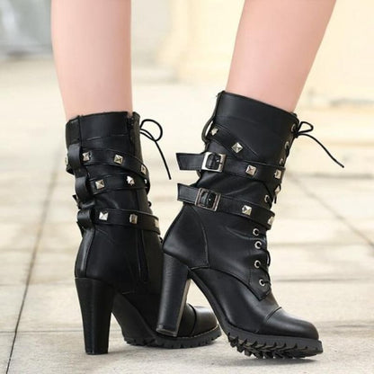 Black leather high-heeled ankle boots with studs, buckles, and laces.