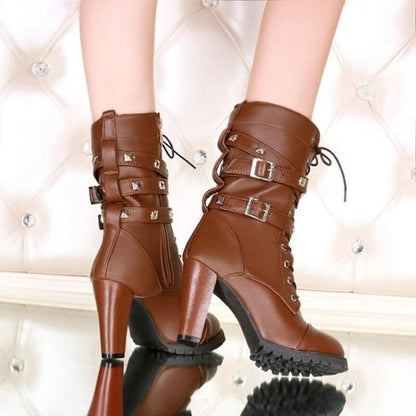 Pair of brown leather high-heeled ankle boots with buckles and laces.