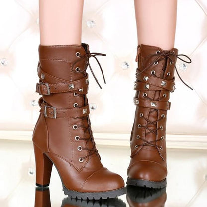 Brown leather high-heeled combat boots with buckled straps and lace-up fronts.