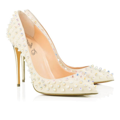 White high-heeled pump adorned with metallic spikes and studs.