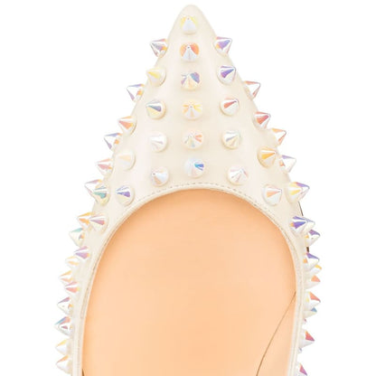 Pointed toe of a white spiked high heel shoe.