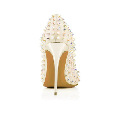 High-heeled white shoe adorned with colorful spikes.