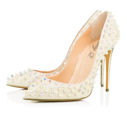 White high-heeled shoe adorned with spikes and crystals.