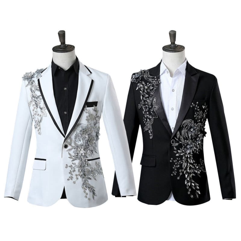 Two stylized men’s blazers with floral embroidery designs, one white and one black.