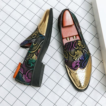 Pair of ornate loafers with colorful floral embroidery and metallic gold accents.