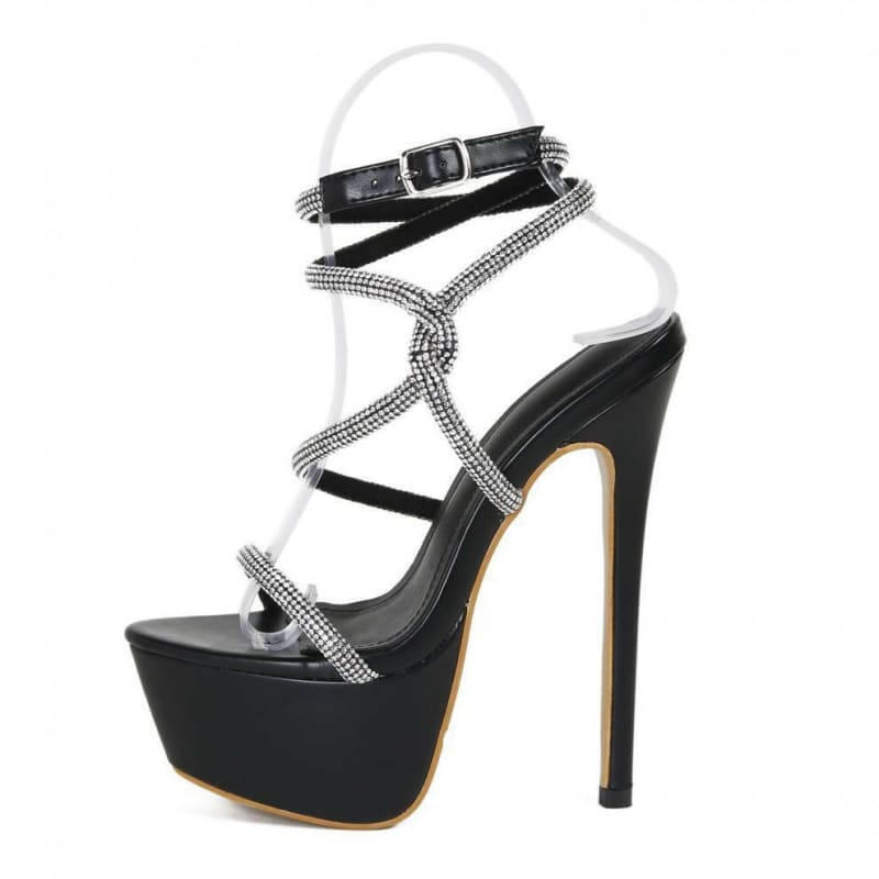 High-heeled platform sandal with rhinestone-studded straps and an ankle buckle.