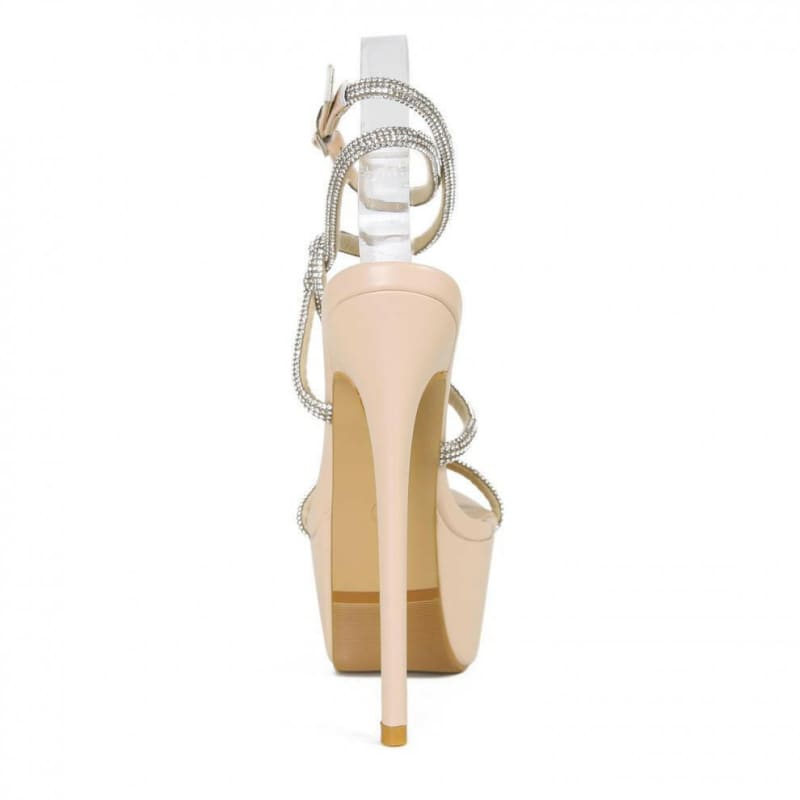 High-heeled platform sandal with thin straps and a nude-colored heel.