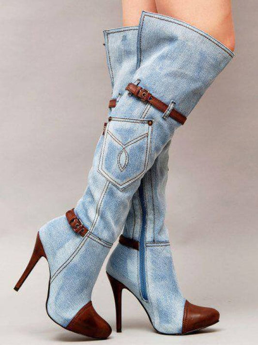 Knee-high denim boots with brown leather accents and stiletto heels.